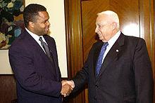 Jesse Jackson, Jr. shaking hands with former Israeli Prime Minister Ariel Sharon on a 2003 trip to Israel