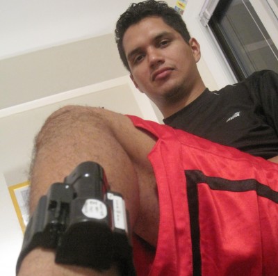 Matias Ramos shows the ankle monitoring device he had to wear for ten days. Photo by Michael Vanacore.
