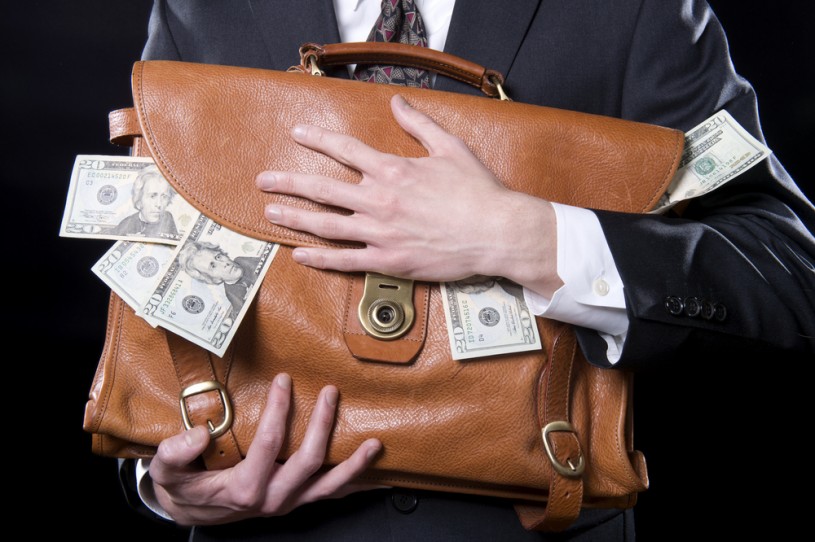 Businessman with a briefcase full of money