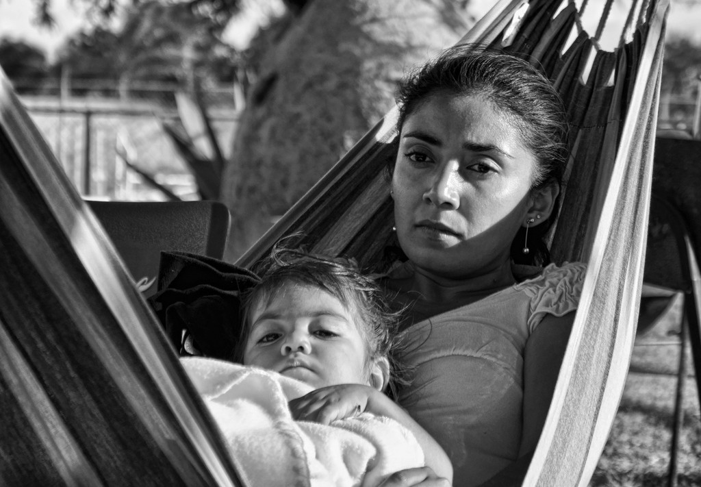 mother contemplative with child in hammock