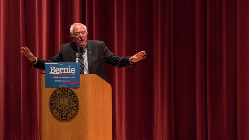Bernie Sanders stands at campaign podium