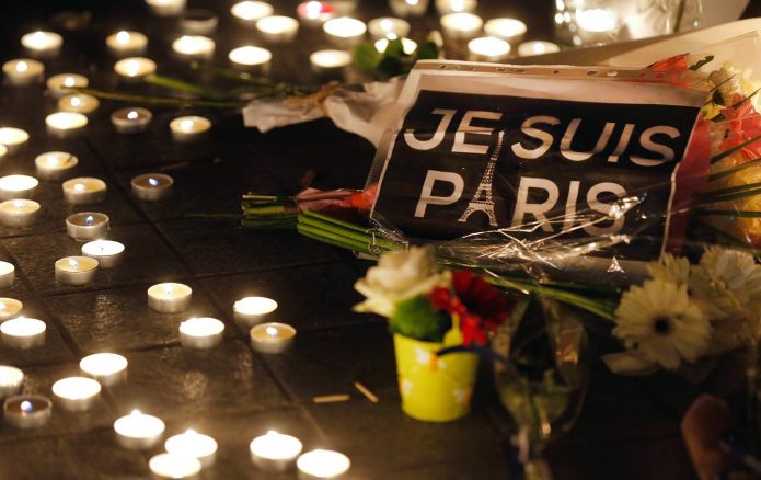 Flowers and candles are placed near the scene of a shooting the day after a series of deadly attacks in Paris , November 14, 2015. Reuters/Vincent Kessler