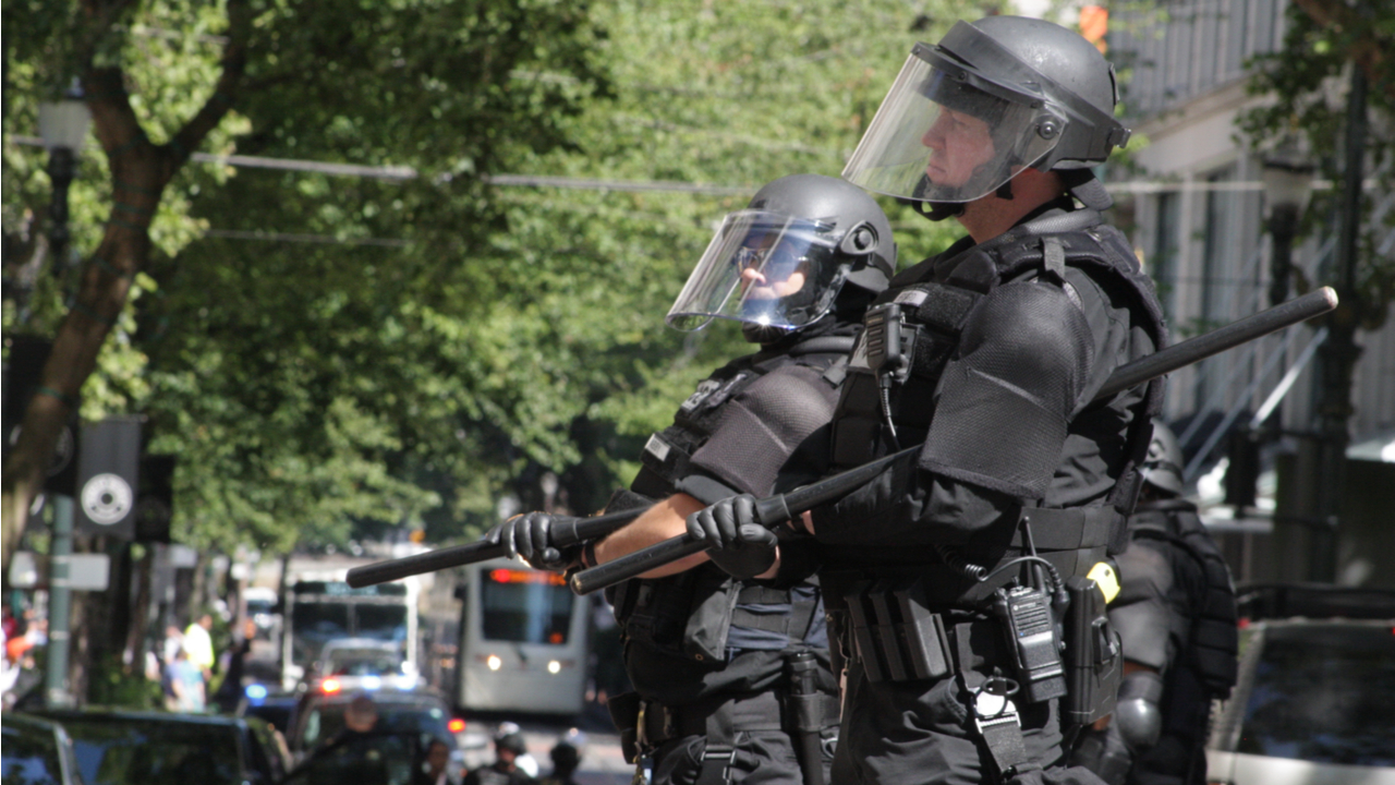 police stand in militarized riot gear
