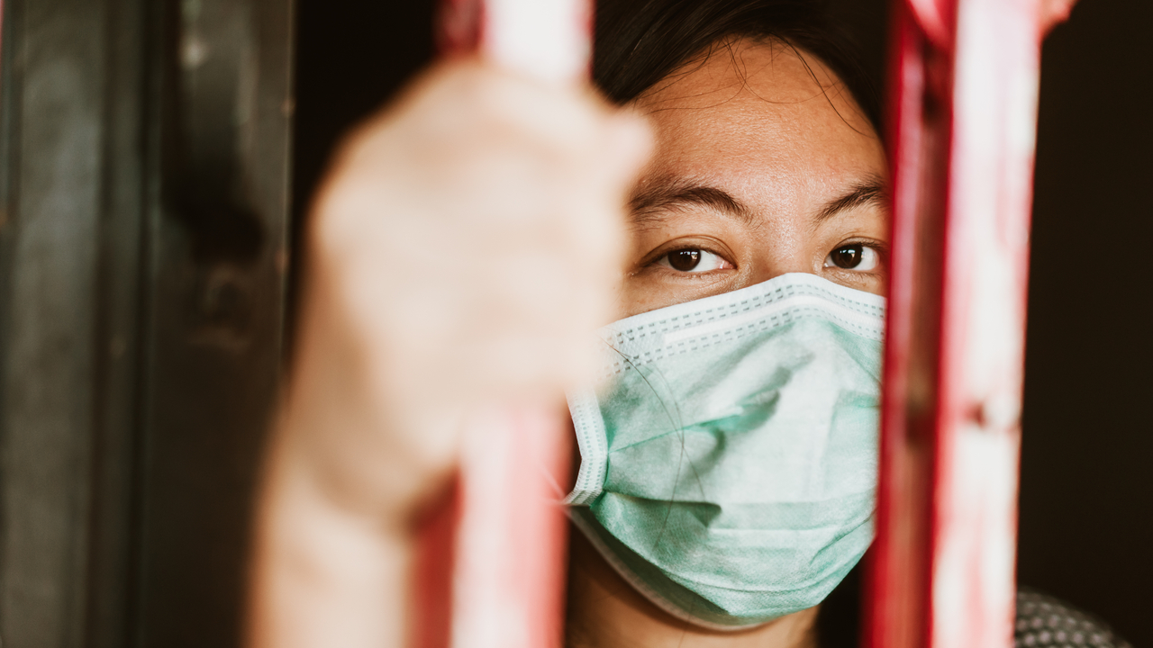 woman behind bars due to coronavirus crisis in prison