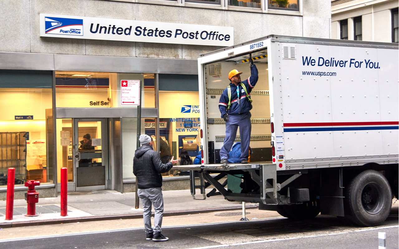 USPS postman on a mail delivery truck in New York. USPS is an independent agenc of US federal government responsible for providing postal service in the US