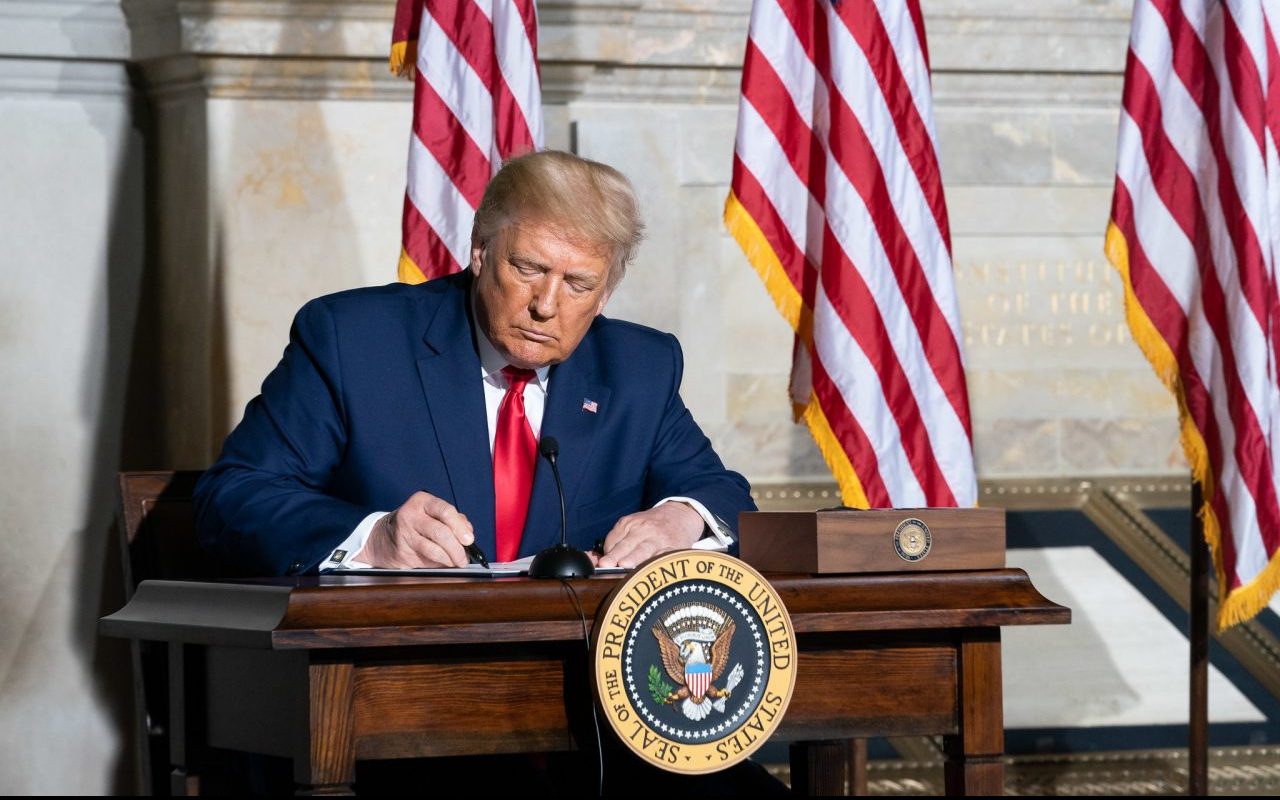tax-taxation-trump signing a document
