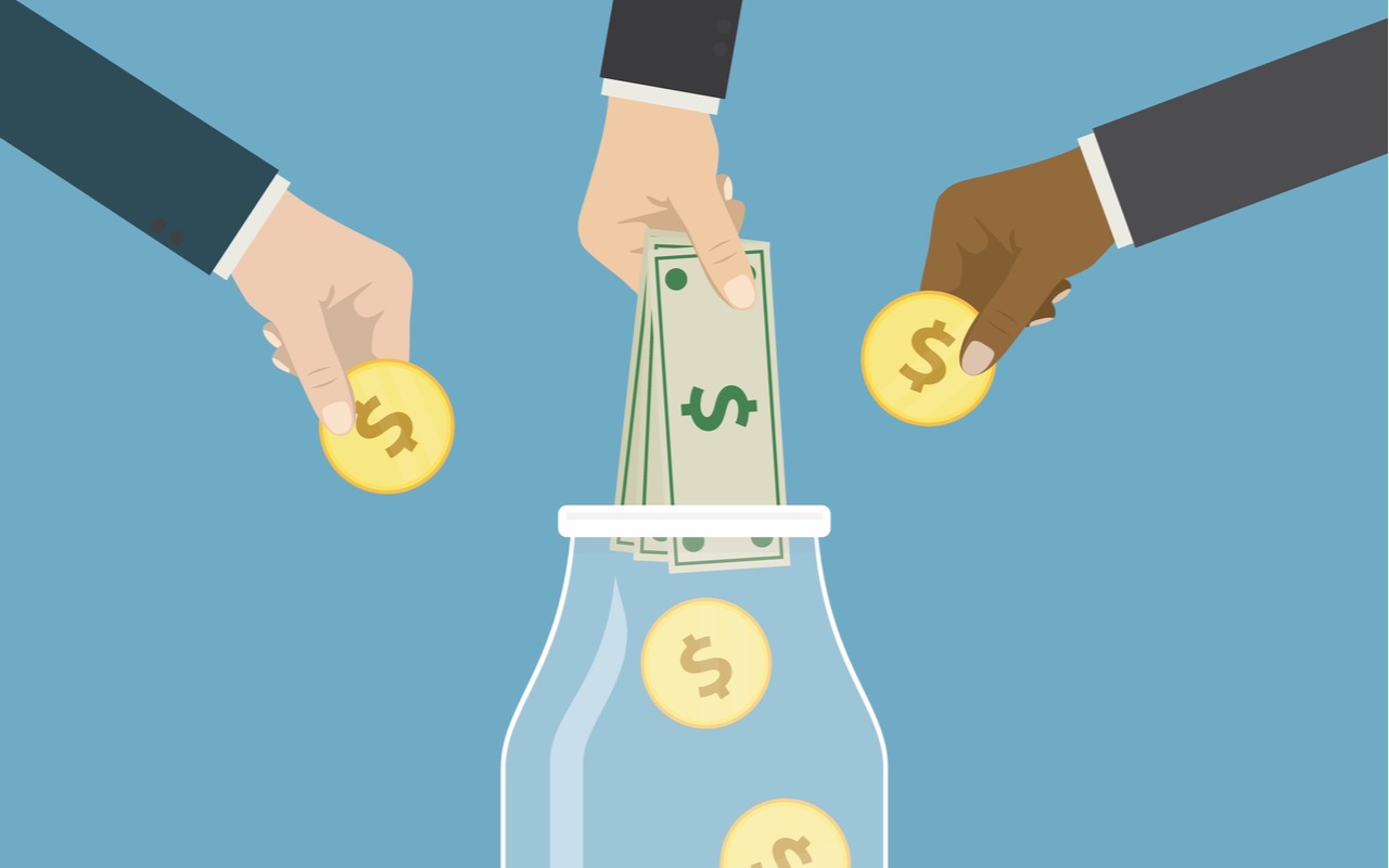 billionaire charity - hands putting money in a jar