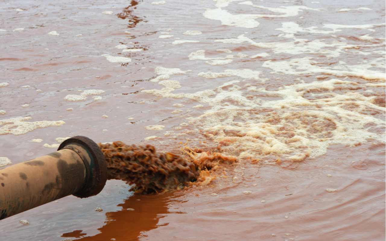 dirty water discharged into a river to depict environmental racism