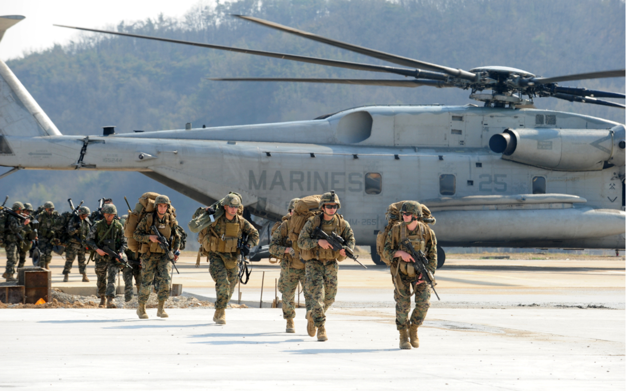 U.S. military soldiers exiting a plane and running toward an objective