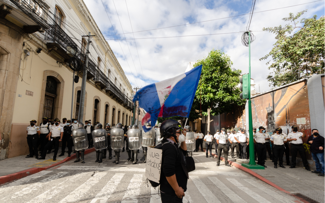 A demonstrator confronts police in Guatemala