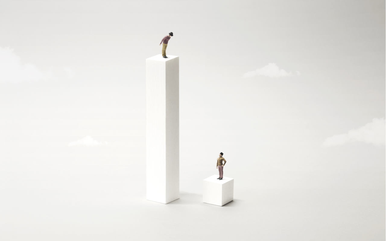 two people standing far apart to depict inequality
