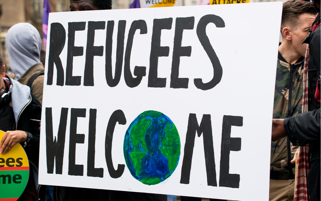sign that reads refugees welcome