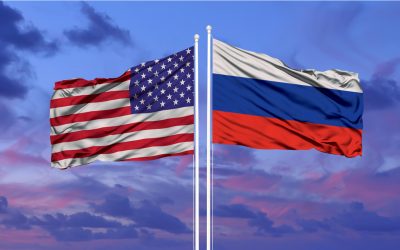 united states flag and russian flag blowing in the wind
