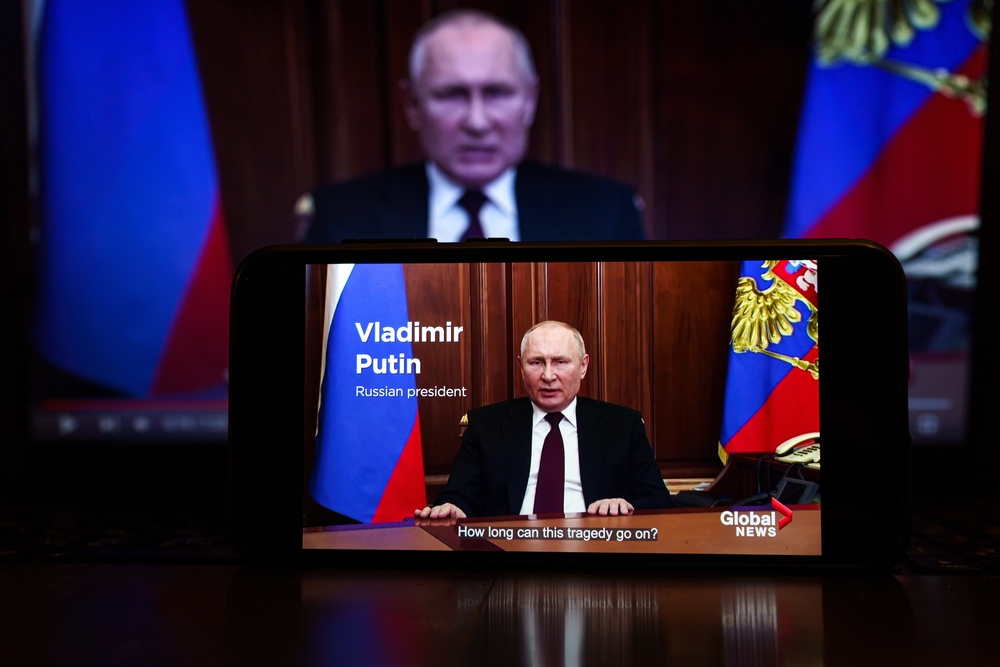 Vladimir Putin speaks about the war in Ukraine on Russian state TV. (Shutterstock)