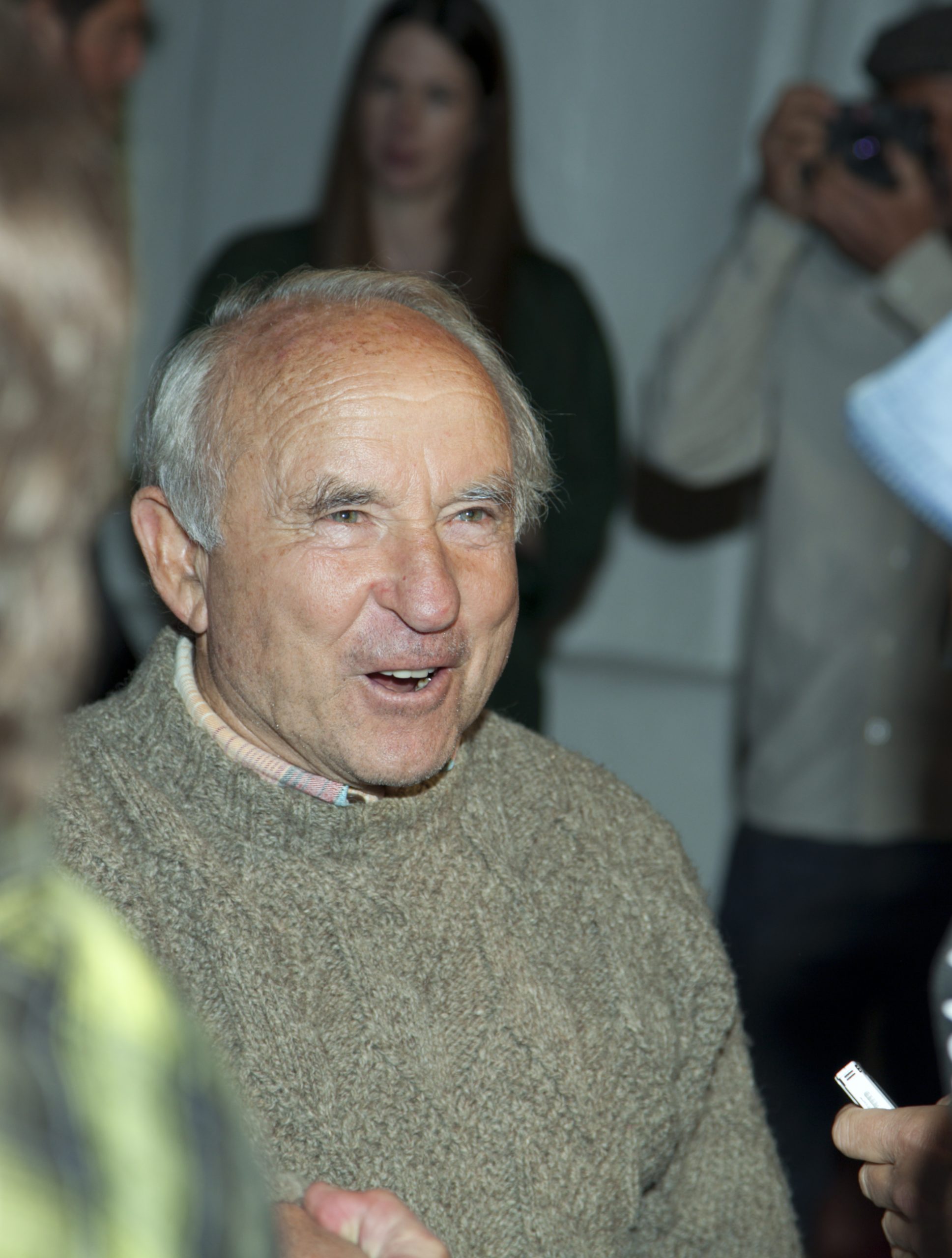 Photo of Yvon Chouinard, Patagonia's founder, in a grey-green sweater, with light skin, grey receding hair and dark eyes.