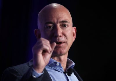 Jeff Bezos speaking to an audience using hand gesture.
