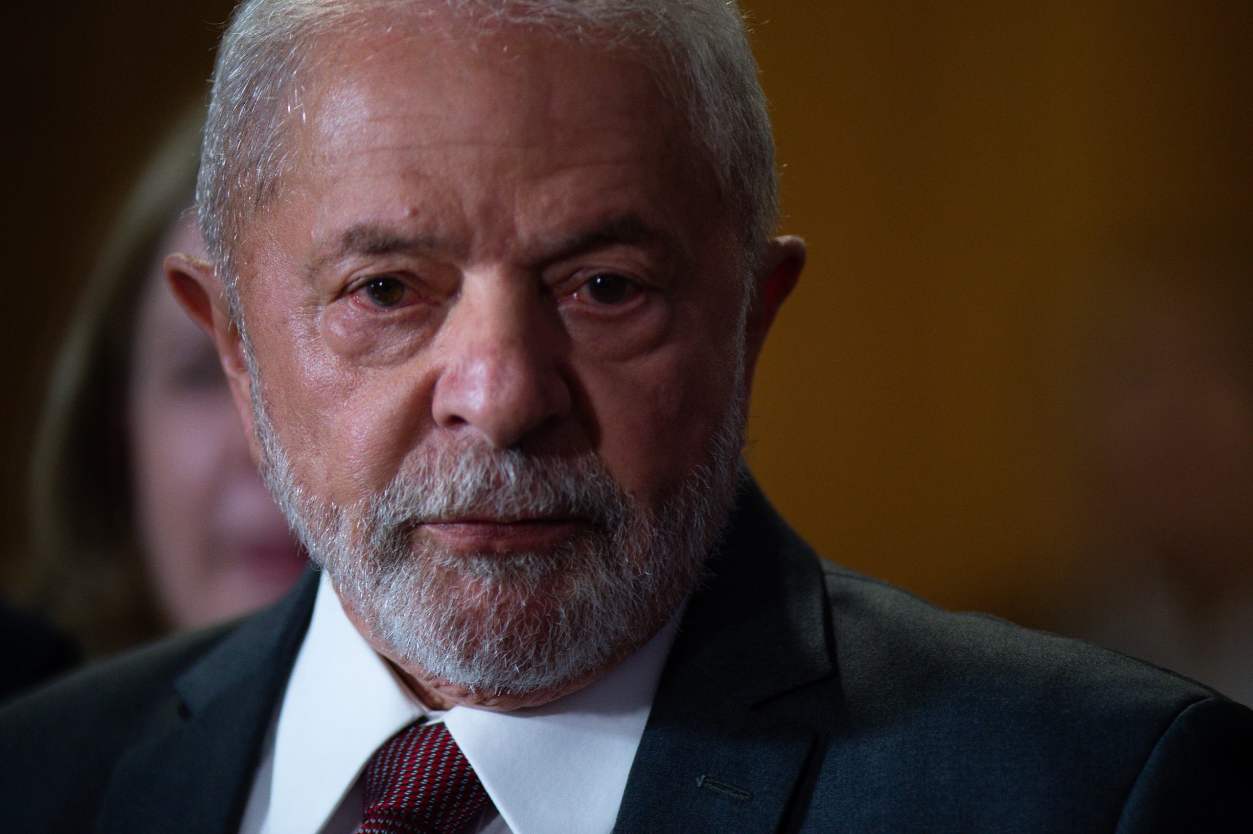 Close up shot of Brazilian president Lula da Silva, who's wearing a white shirt, a tie, and a dark suit.