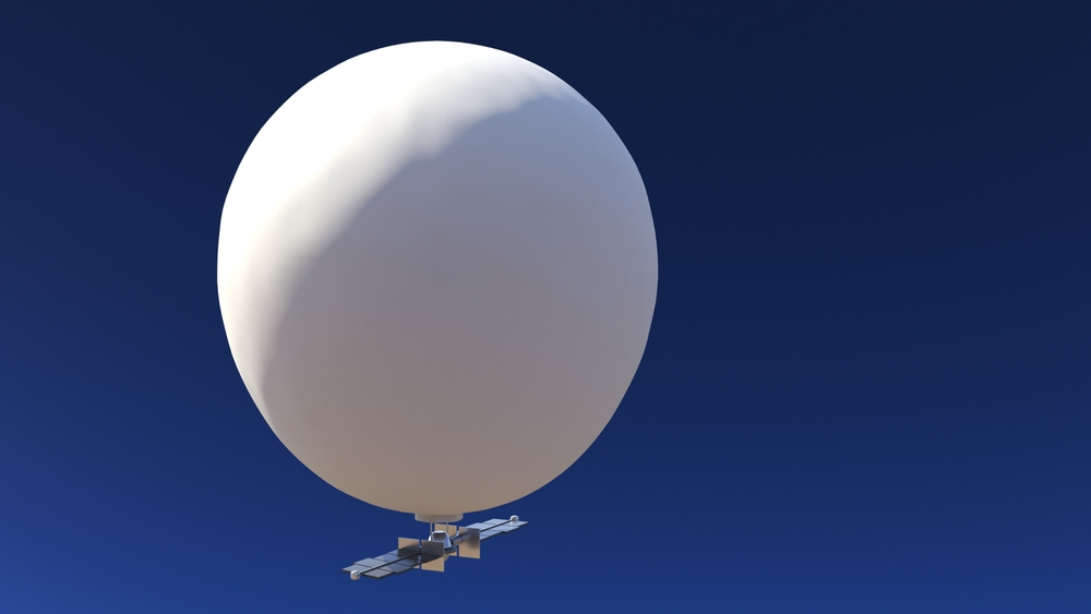 Close-up image of white spy balloon with blue sky in the background
