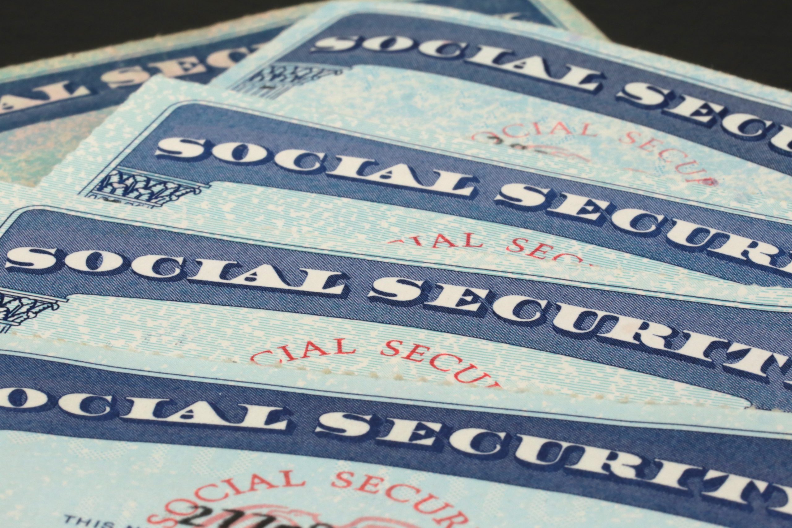 5 social security cards stacked and slightly fanned out.