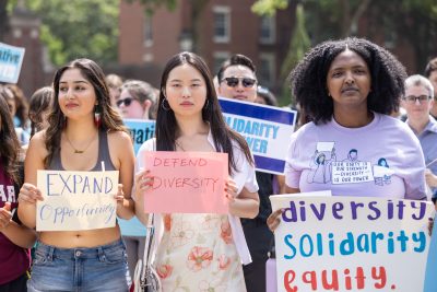 Image of Harvard students protesting recent ruling on Affirmative Action. They're holding signs that read "diversity," "solidarity," "equity."